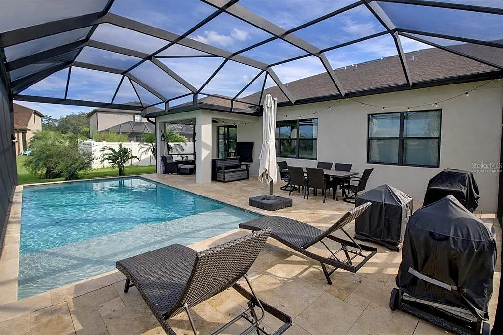 Home with screened pool and covered patio